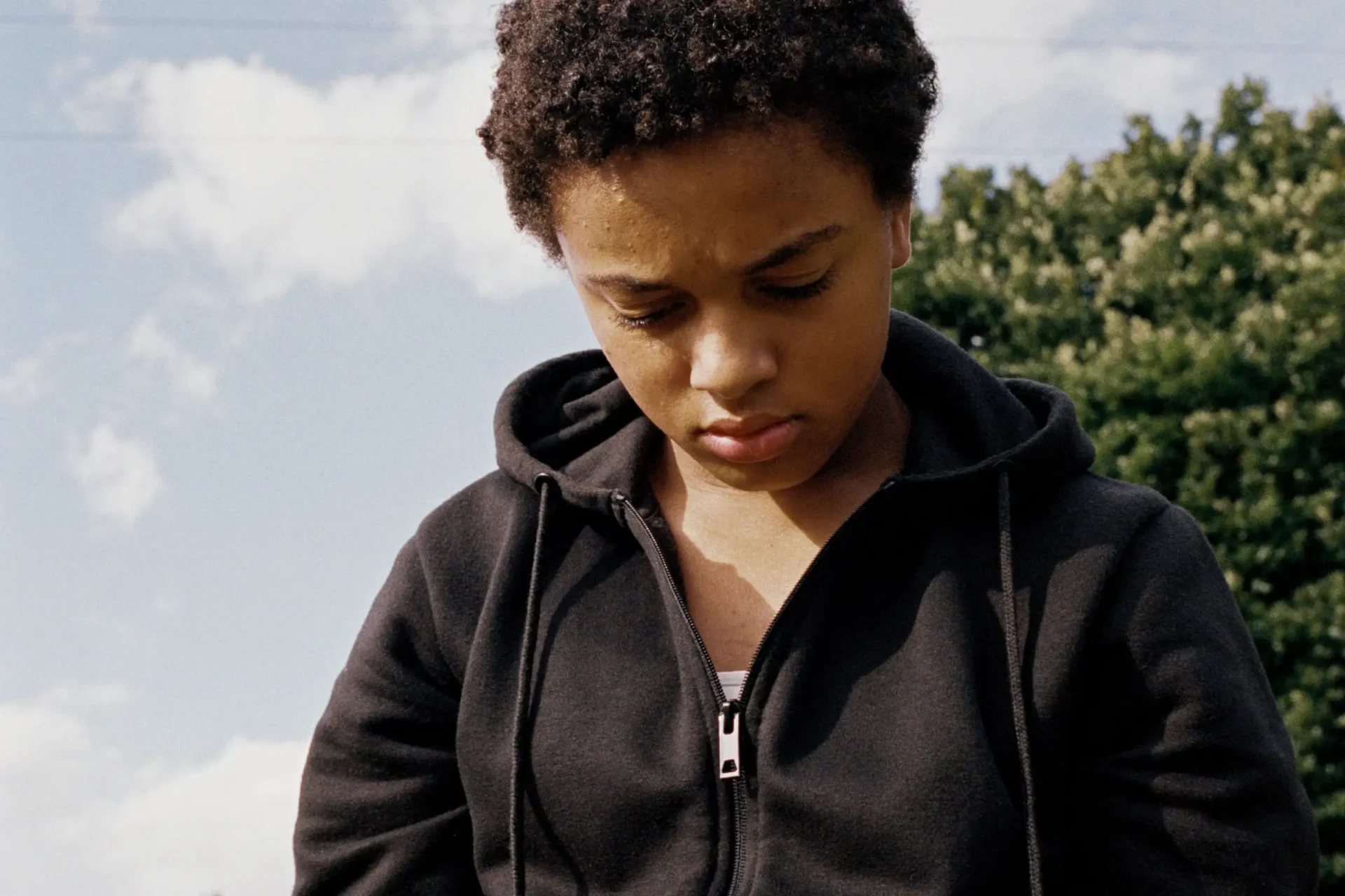 Nykiya Adams looks down in a still from Bird, the film this interview is about