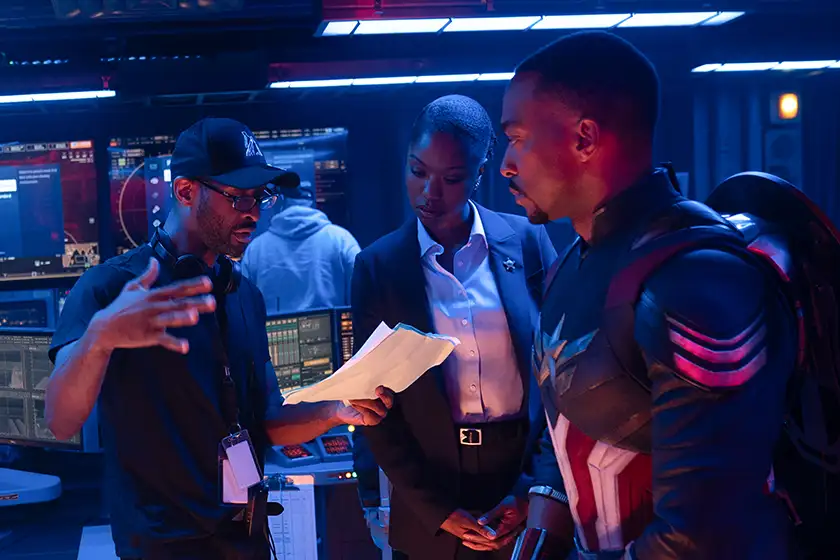 Director Julius Onah, Xosha Roquemore, and Anthony Mackie behind the scenes of Captain America: Brave New World, in a photo featured in an article on everything we know about the movie