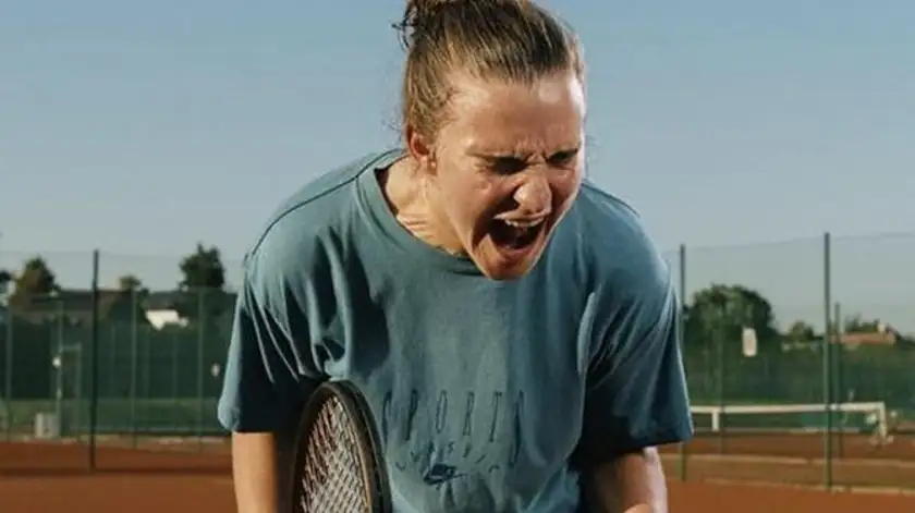 A tennis player screams in frustration in a still from the film Julie Keeps Quiet