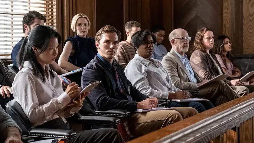 Nicholas Hoult sits in a courtroom as a member of the jury in the Clint Eastwood film Juror #2