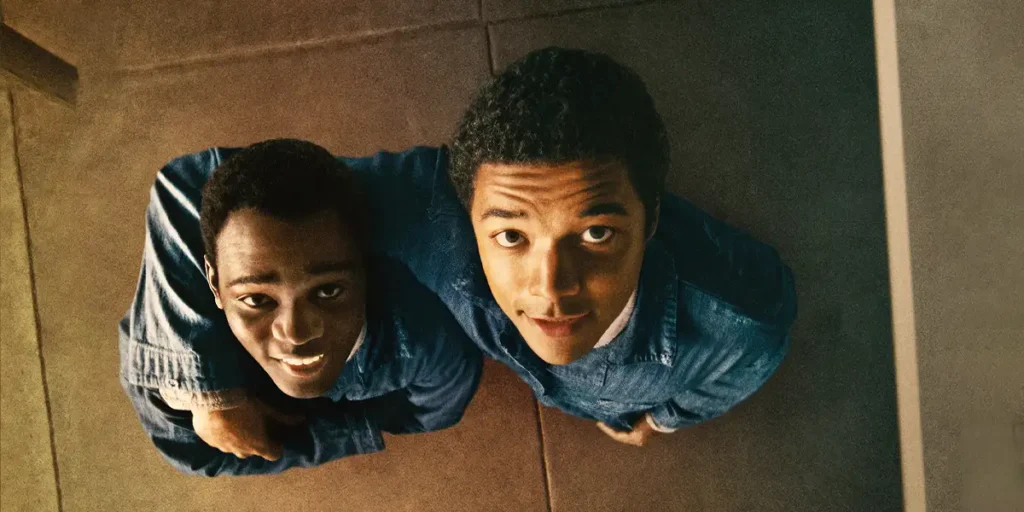 Two boys look up in a shot from above in a still from the film Nickel Boys