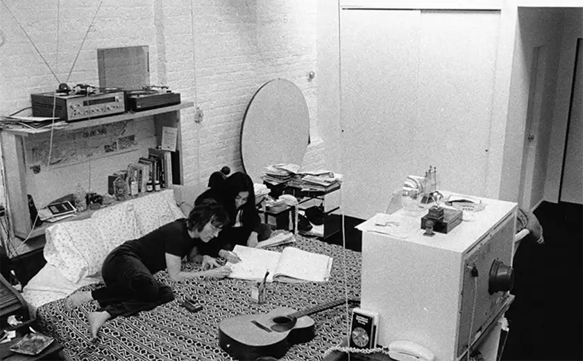 John Lennon and Yoko Ono on their bed in the film One to One: John and Yoko