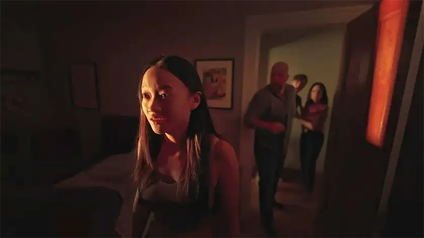 A woman stands in a bedroom with three people behind her in a still from Presence, one of the 10 anticipated movies to watch in January 2025