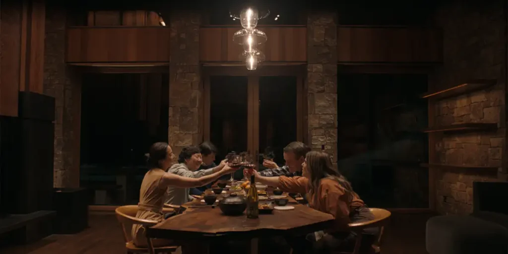 People make a toast at a dinner table in A Great Divide