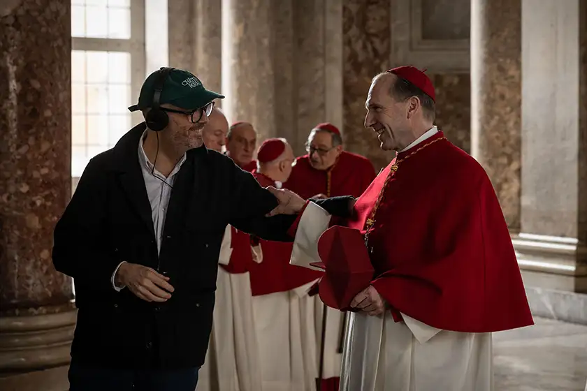 Director Edward Berger and actor Ralph Fiennes on the set of Conclave, whose producer, Michael Jackman, we interview