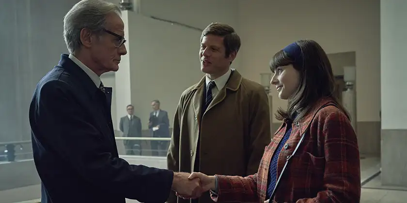 Bill Nighy, James Norton and Thomasin McKenzie shake hands in a still from the film Joy