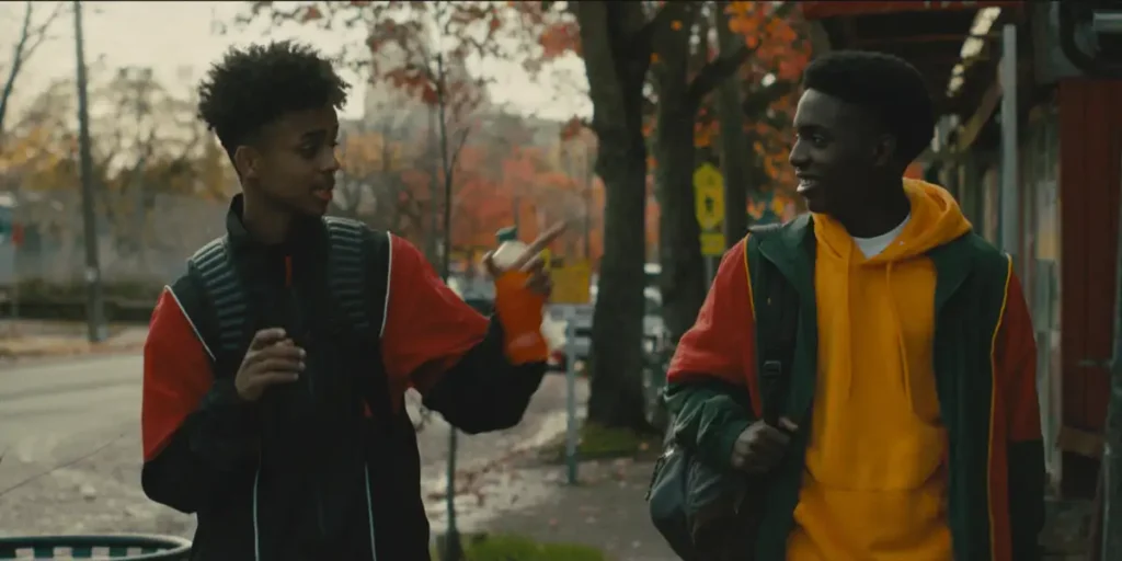 Two Black boys walk and talk to each other in the streets of Seattle in a still from the film Know Your Place