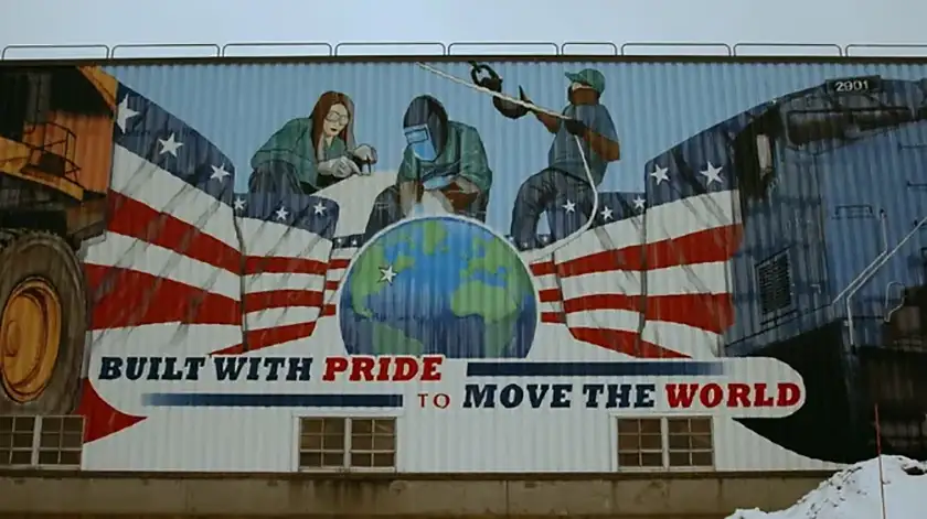 A graffiti reads "built with price to move the world" in the film The American Question