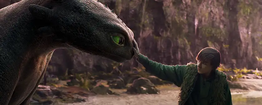 Mason Thames (right) as Hiccup with his Night Fury dragon, Toothless, in a still from the How to Train Your Dragon live action adaptation, which we explore everything we know about in this article