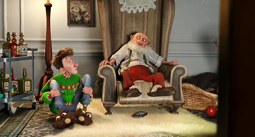 A boy and his grandad sit in the living room in an animated still from the film Arthur Christmas