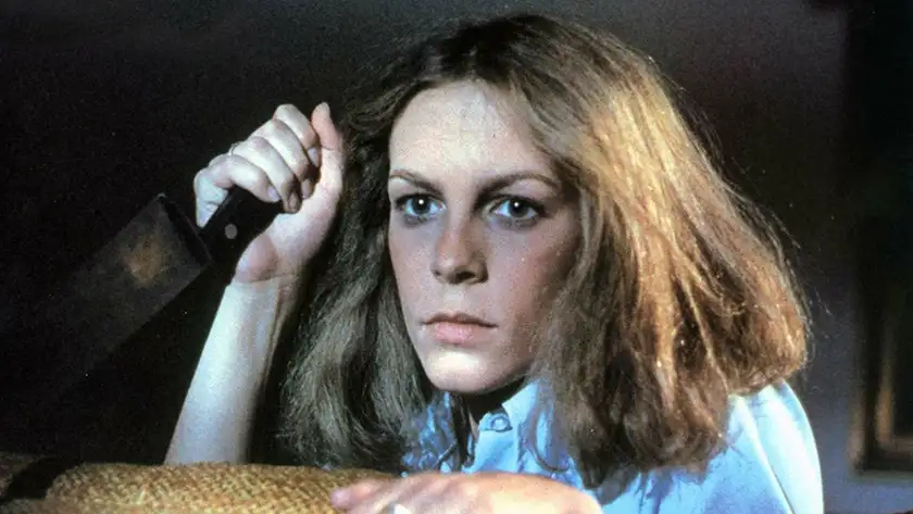 Jamie Lee Curtis holds a knife as Laurie Strode in Halloween (1978)