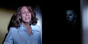 Jamie Lee Curtis, as Laurie Strode, hides from Micheal Meyers in Halloween (1978)