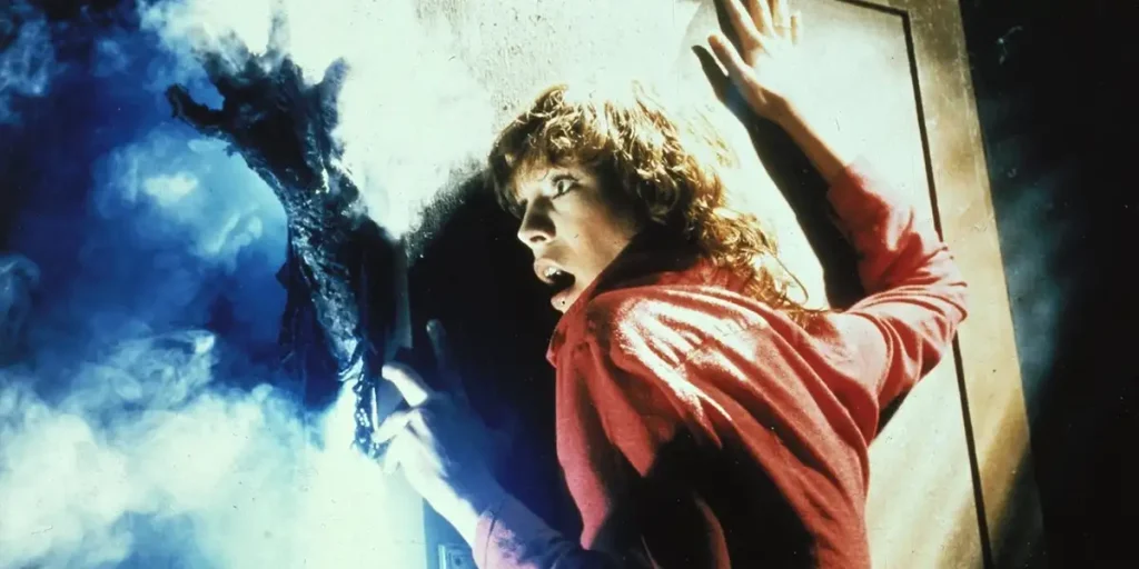 Debra Hill leans on a wall with a creepy hand in front of her in the John Carpenter film The Fog (1980)