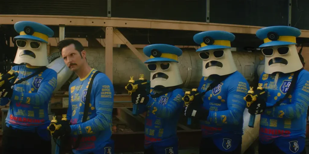 Four cartoon cops and a man in a blue suit stand holding water pistols in the film Clone Cops