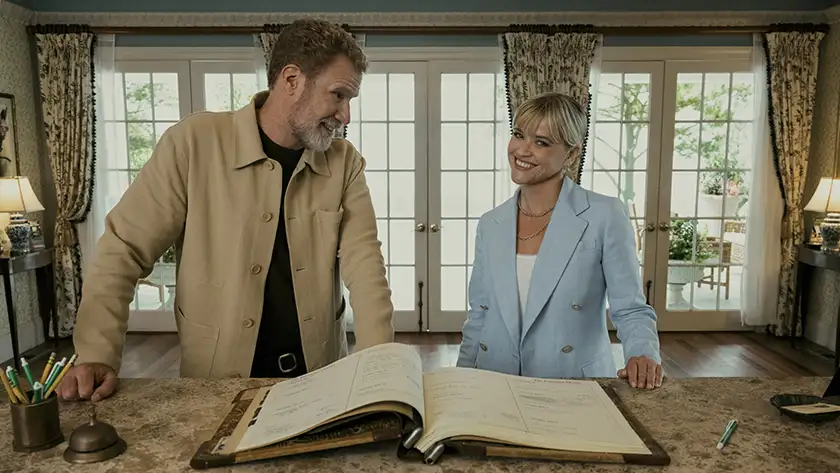 Will Ferrell and Reese Witherspoon stand with a big book open in front of them in the movie You’re Cordially Invited