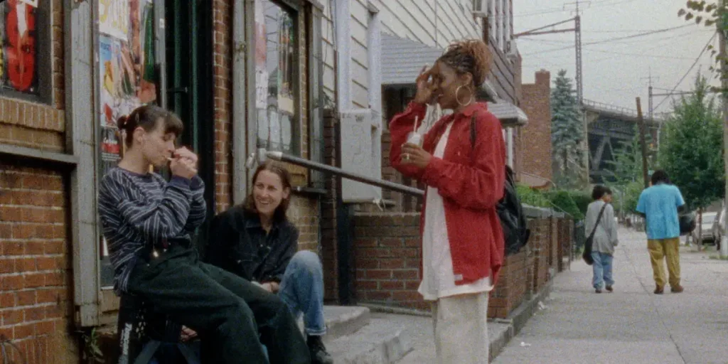 Three girls talk by a street in a still from the film Girls Town