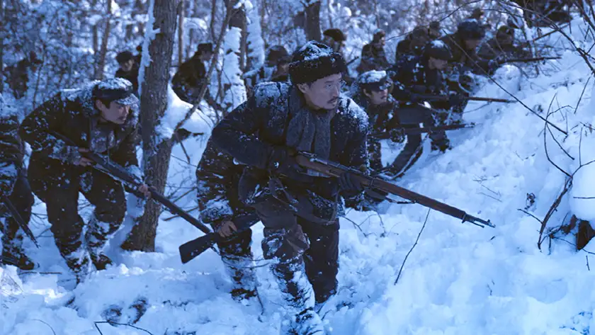 Soldiers hold rifles in the snow in a still from the movie Harbin