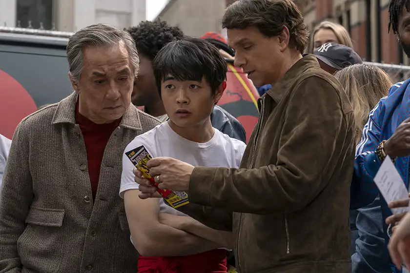 Jackie Chan, Ben Wang and Ralph Macchio in a still from Karate Kid: Legends, featured in an article with everything we know about the movie