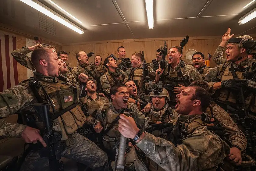 Soldiers cheer inside a truck in a still from the movie Warfare (2025), which this article explores everything we know about