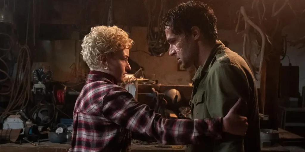 Charlotte (Julia Garner) and Blake (Christopher Abbott) stand in front of each other in Wolf Man (2025), directed by Leigh Whannell