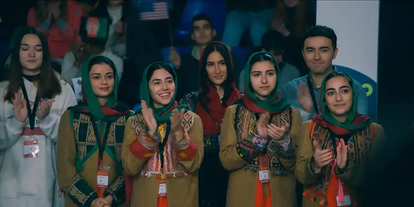 Four Afghan women clap in a still from Rule Breakers