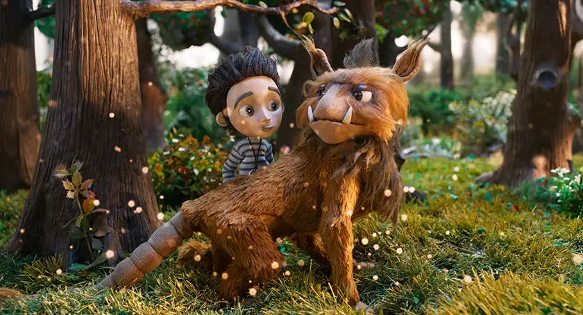 A boy stands next to a magical creature in the stop-motion animated movie Tales From the Magic Garden