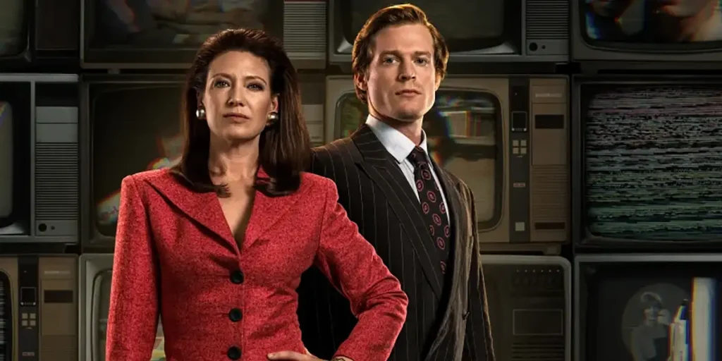 A woman in a red suit and a man in a brown suit and tie stand in the official promo image from series The Newsreader