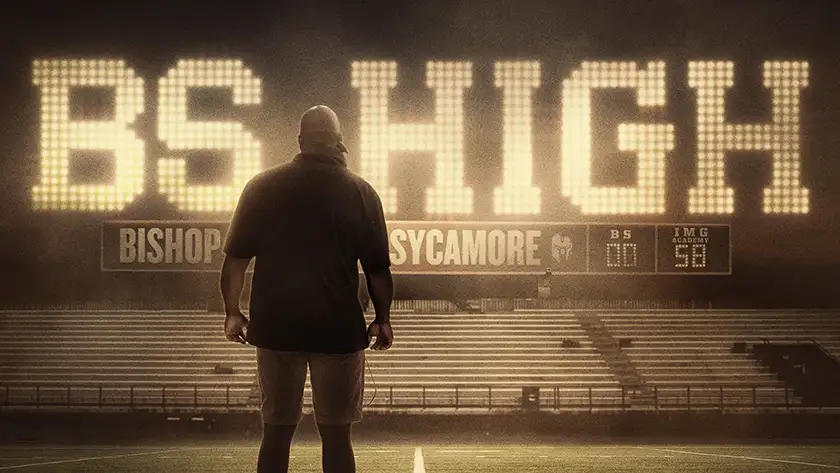 A man stands looking at an American football pitch in the poster for BS High