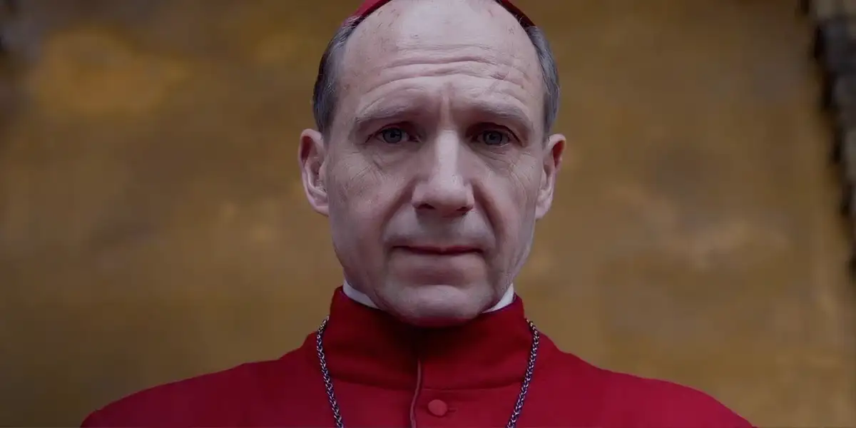 Ralph Fiennes looks down in the final scene of the movie Conclave, one of the Top 10 Movies on Faith and Doubt according to Loud and Clear Reviews