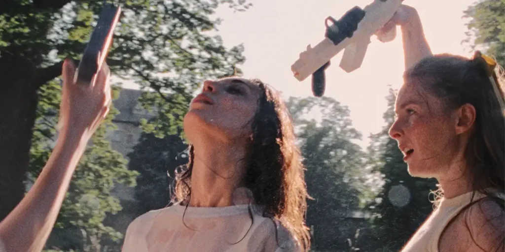 Two women are outdoors trying to get relief from the heat in a shot from the movie Glorious Summer