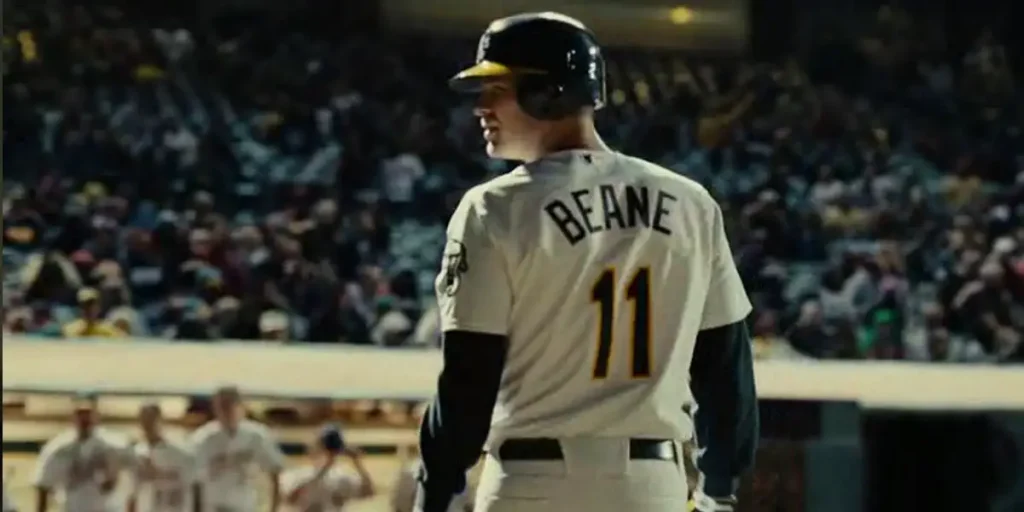 A man wears a Beane shirt during a baseball game in the movie Moneyball