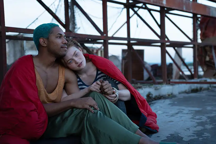 Sadie Sink and Kelvin Harrison lean on each other under a bridge Jr. in O'DESSA