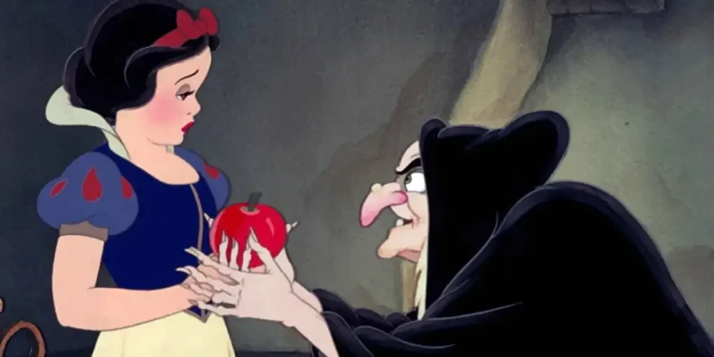 The Evil Queen hands snow white an apple in Snow White and the Seven Dwarfs (1937)