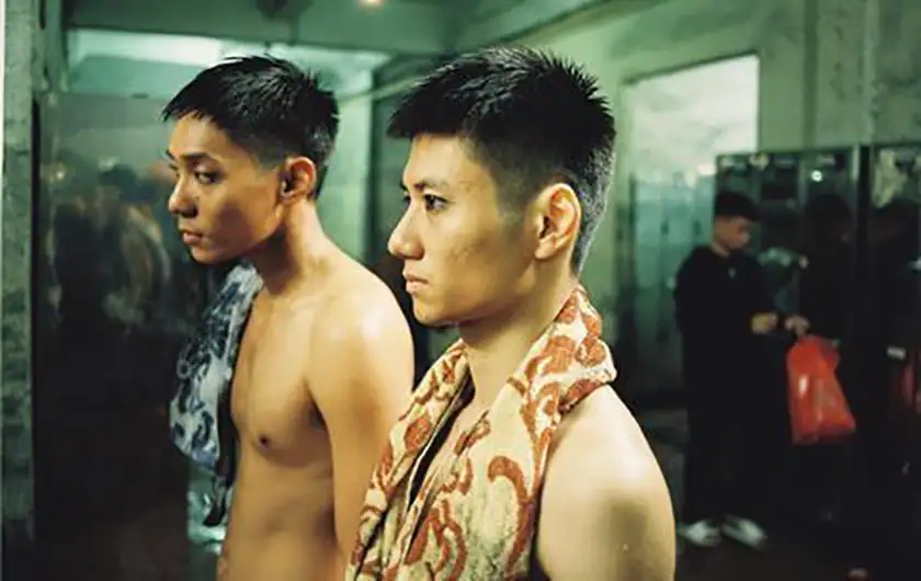 Two boys stand with a towel over their shoulders in a still from the film Việt and Nam, one of the 10 Movies to Watch at BFI Flare 2025 according to Loud And Clear Reviews