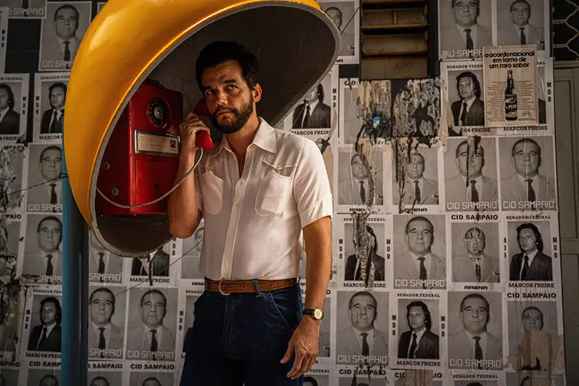 A man speaks on the phone in a still from the film The Secret Agent (O Agente Secreto), one of the 20 movies to watch at the 2025 Cannes film festival according to Loud and Clear Reviews