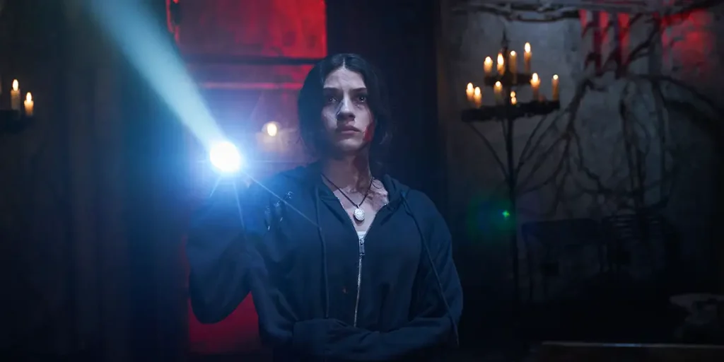 Ella Rubin holds a torch in the dark in the 2025 movie Until Dawn