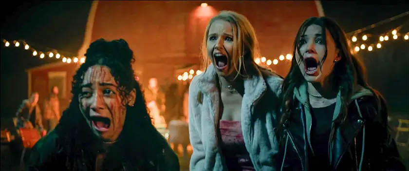 Three girls scream in a still from Clown in a Cornfield