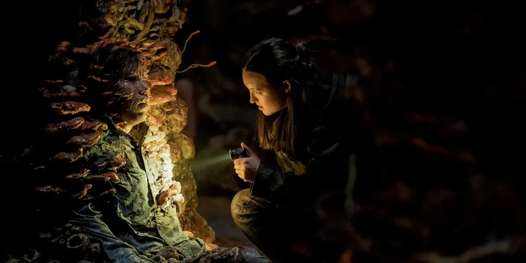 Bella Ramsey as Ellie shines a light on an infected in episode 5 of The Last Of Us Season 2