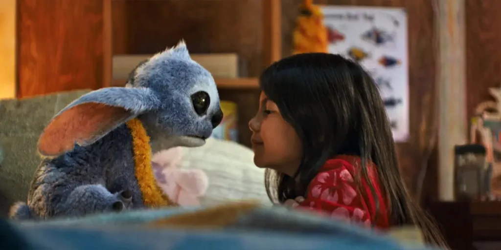 Stitch looks at Lilo from the couch in Disney’s live-action Lilo & Stitch (2025)