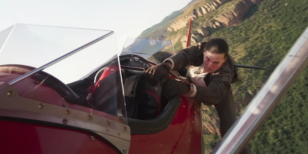 Tom Cruise hangs off a red plane in Mission: Impossible - The Final Reckoning
