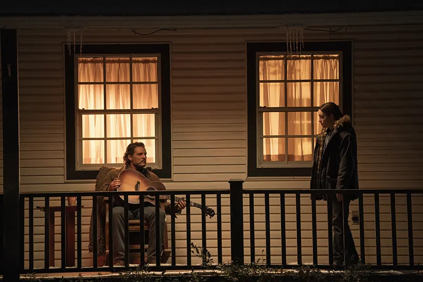 Pedro Pascal (Joel) gives Bella Ramsey (Ellie) a guitar in episode 6 of The Last Of Us Season 2