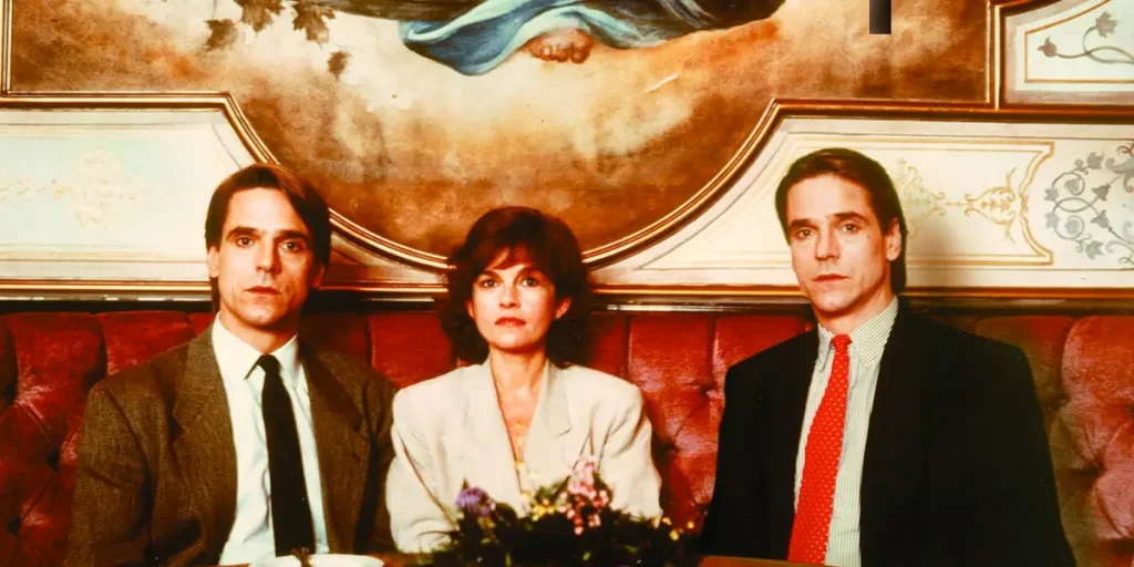 Geneviève Bujold sits between two characters played by Jeremy Irons in Dead Ringers