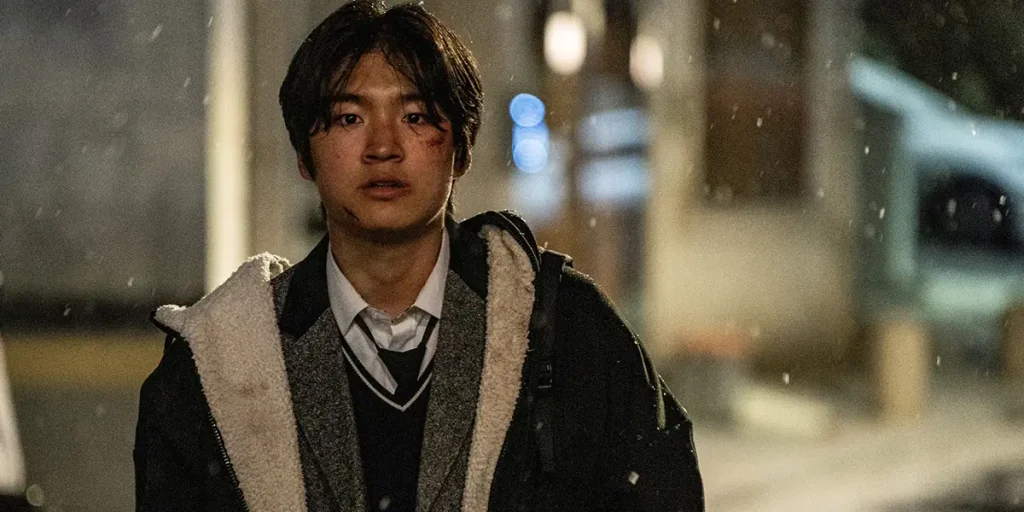 A young man stands in the snow at night in Fragment (Pa-pyeon - 파편)