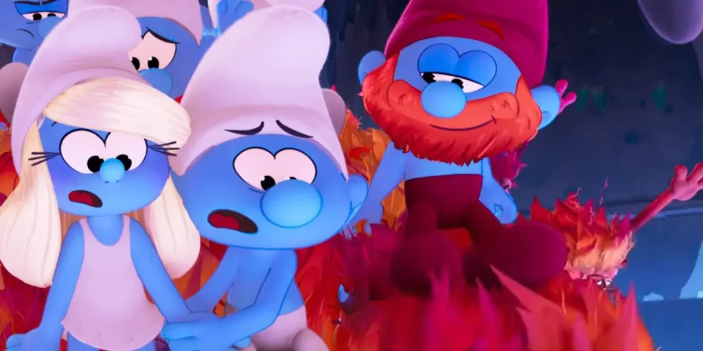 Papa Smurf stands on the right smiling and looking down at Smurfette and another Smurf who both look scared in the 2025 film "Smurfs"