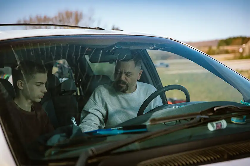 Nick Offerman and Jacob Tremblay are in a car in the 2025 movie Sovereign