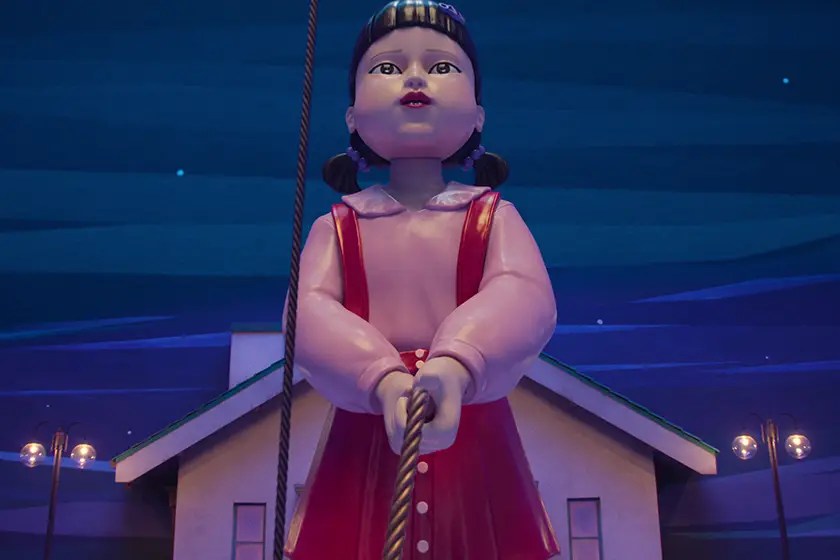 The giant doll holds a rope in one of the games from Squid Game Season 3
