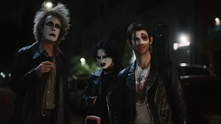 Three people have their faces painted white, black an dread at night in a still from the film I Fell in Love with a Z-Grade Director in Brooklyn