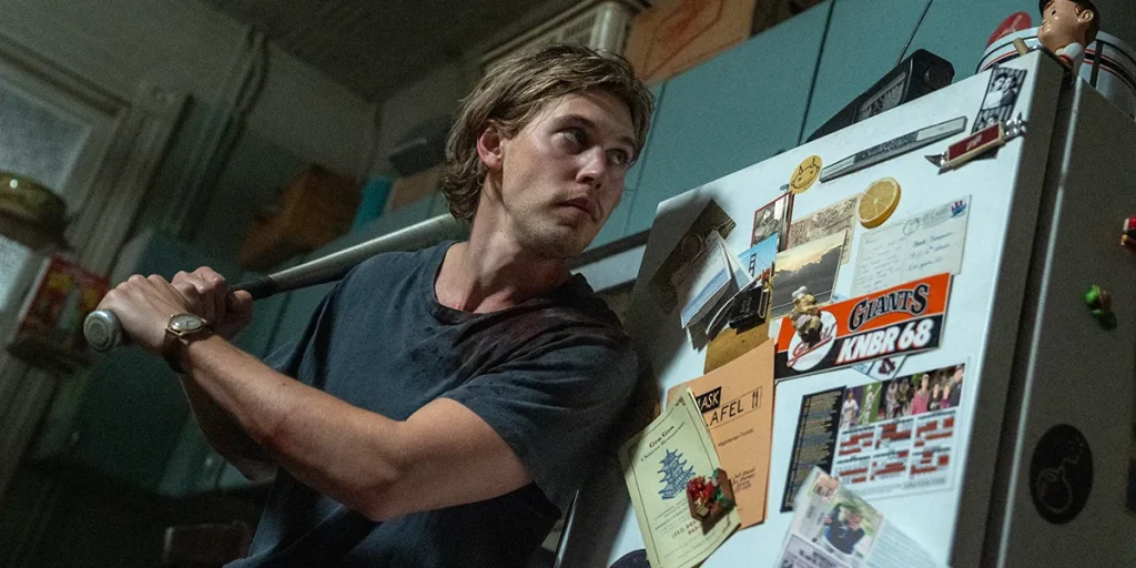 Hank (Austin Butler) stands with a baseball bat in the movie Caught Stealing