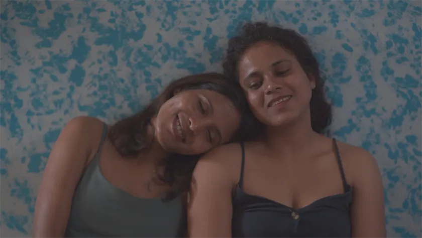 Thooya and Swetha lean on each other in Songs of Forgotten Trees