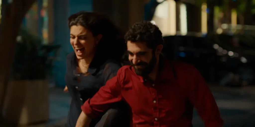 A young man and woman run laughing in A Sad and Beautiful World